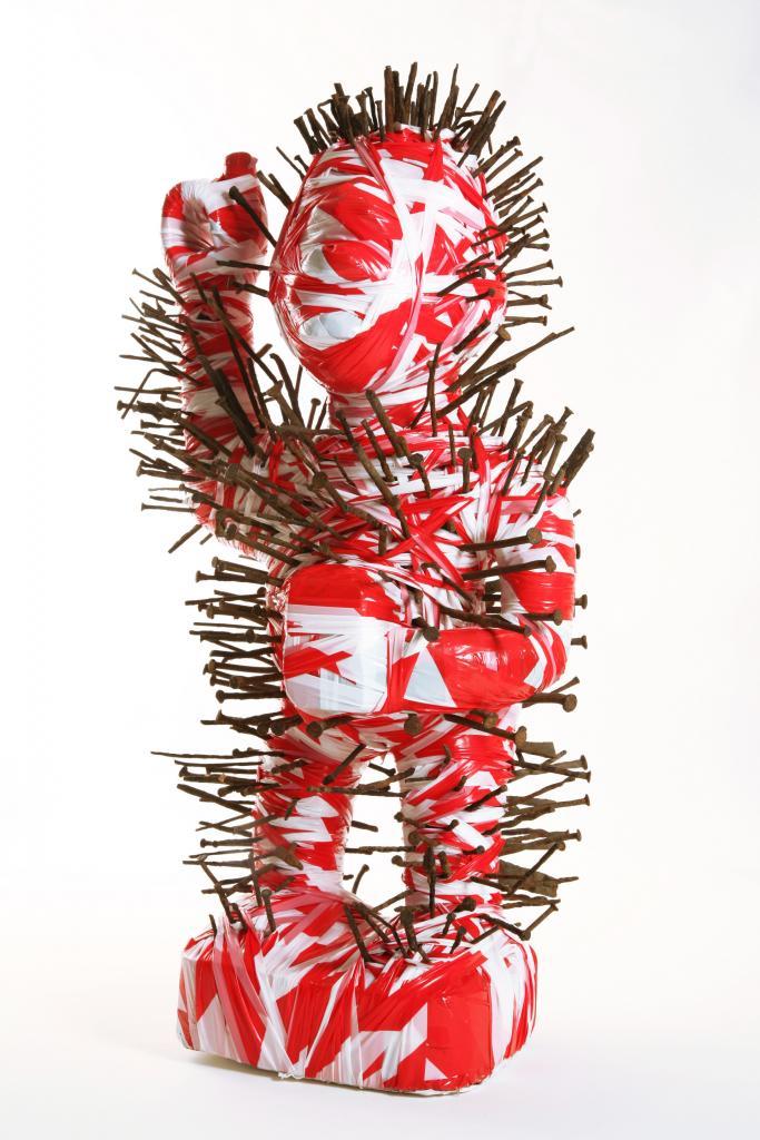 Kendell Geers, Twilight of the Idols (Fetish), Emergency chevron tape, lost object and nails, 2002, 64 X 35 X 30 cm, © Courtesy of the artist