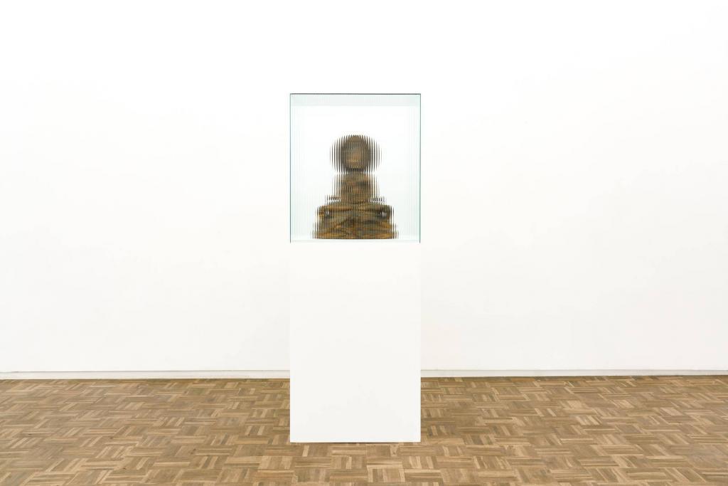 James Webb, This is where I leave you (Radiant guide. Equanimity in the harsh storm) (2020) | Brass Buddha statue, vitrine, plinth ; 161 x 46 x 64 cm