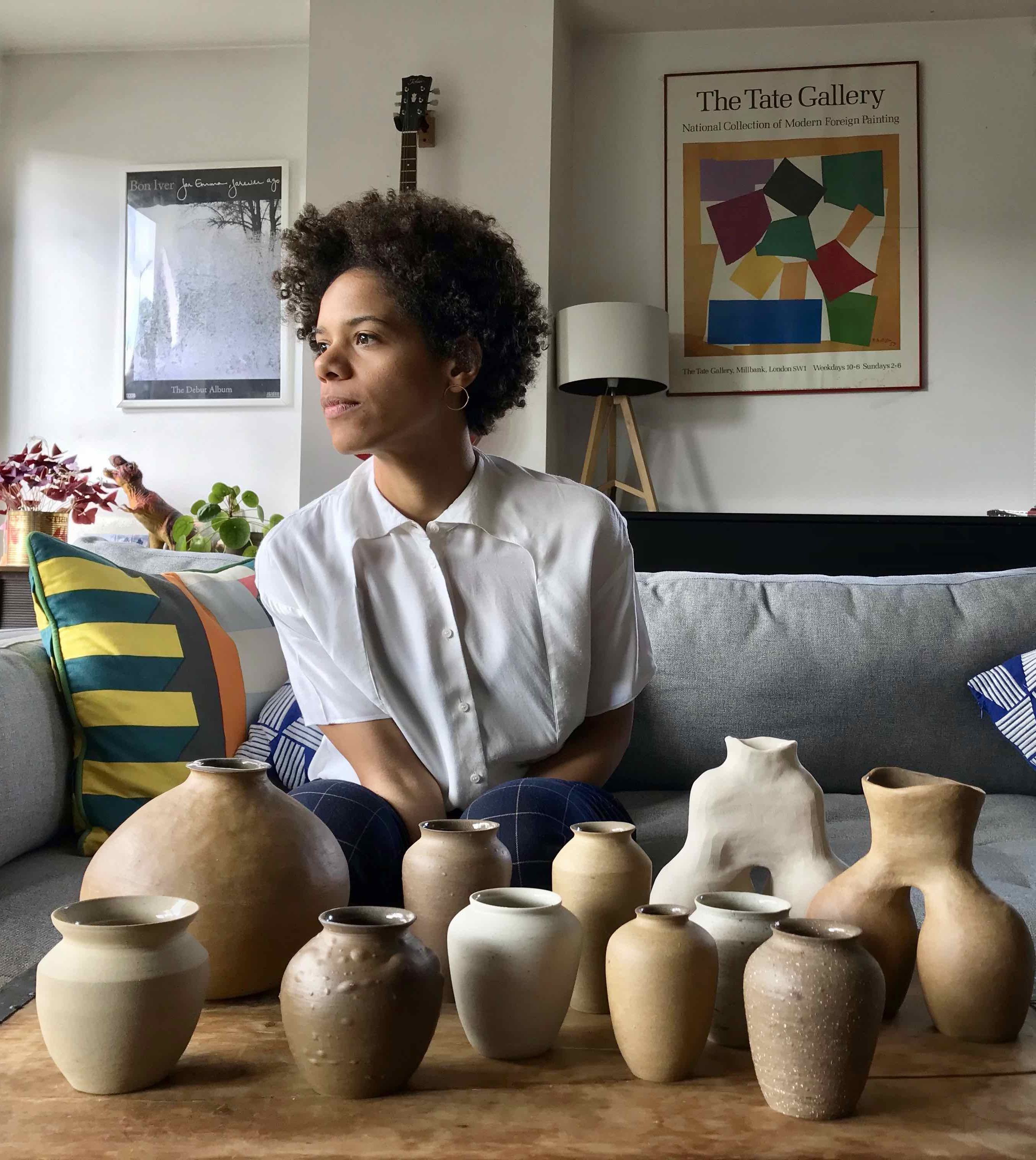 Ceramic Artist Bisila Noha with her vessel and ceramics