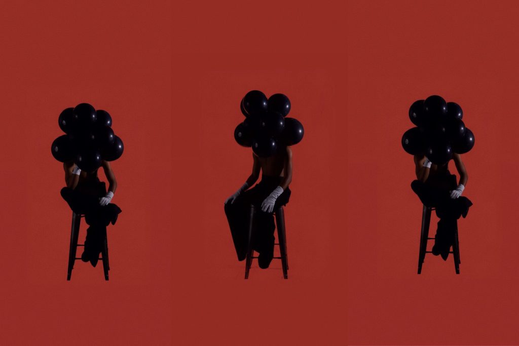 With balloons on his head, K.Skit explores how black bodies often find healing and joy in spite of the generational and ongoing trauma inherited from historical oppression.